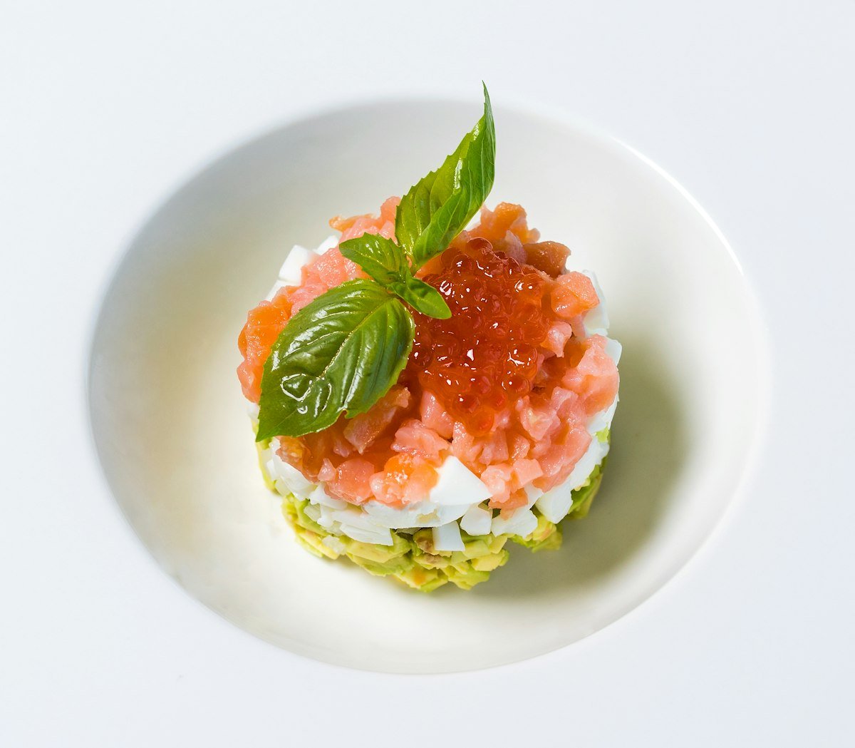 Pan-seared shrimp skewer over green salad